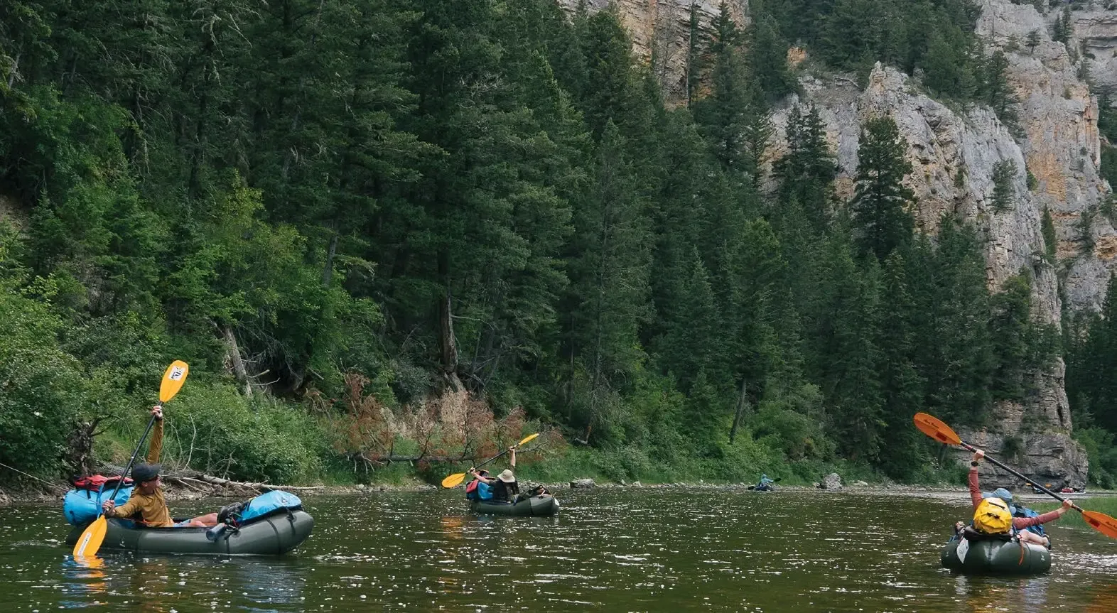 Pack-rafters on the Smith River stretch their arms wide toward the sky