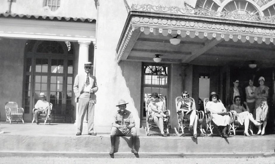 Guests getting sunshine on the front deck of the Gallatin Gateway Inn