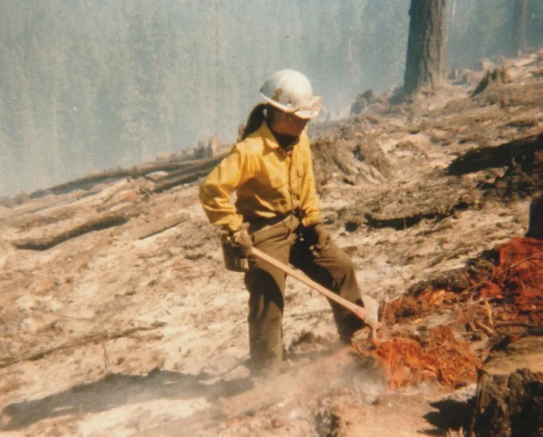 Jeanne-Marie Souvigney working a fireline in yellow Nomex