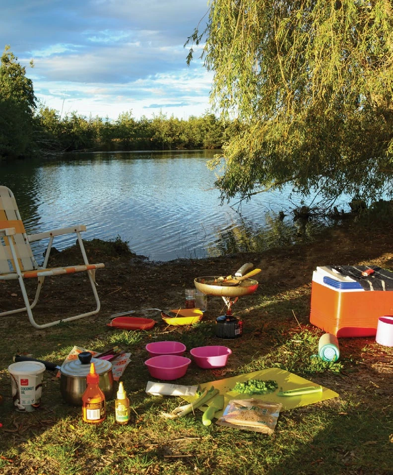 Adventure Guide: Into the fiords, peaks and coastlines of New Zealand’s South Island 8 Evening light on a lakeside camp kitchen as dinner is prepared